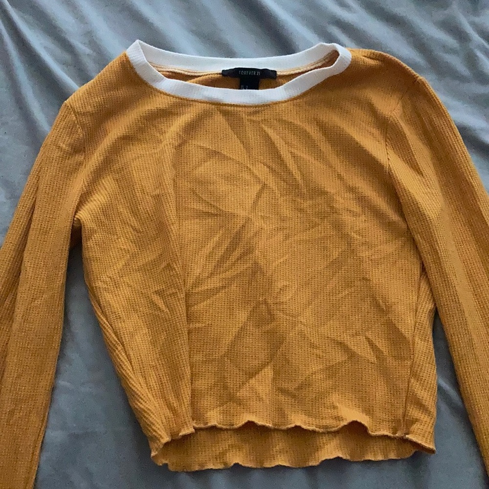A musturd yellow cropped shirt